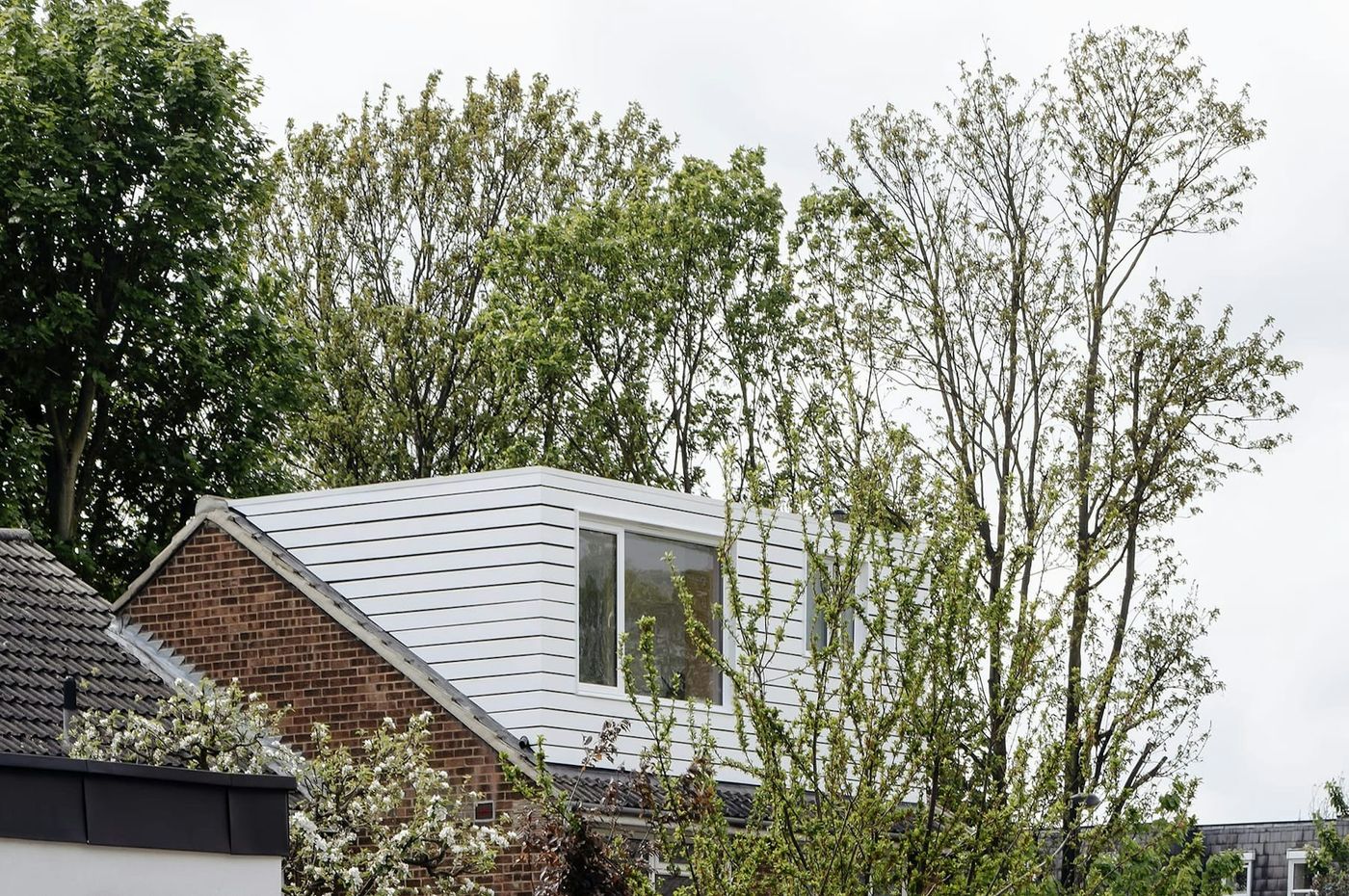 White horizontally clad timber dormer extension designed by From Works in Blackheath, London.