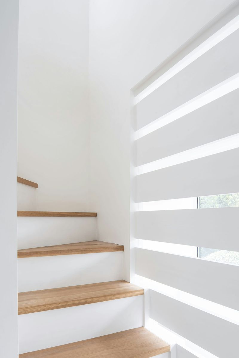 Naturally lit oak and white painted staircase leading up to the new master bedroom suite within From Works loft conversion and rear dormer extension in Blackheath, London.