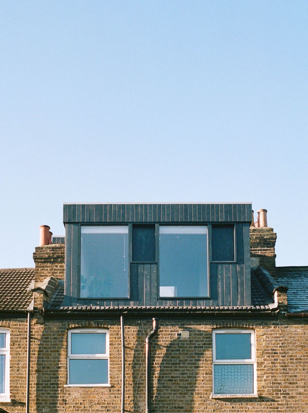 External view of From Works' vertical timber clad rear dormer extension in East London.